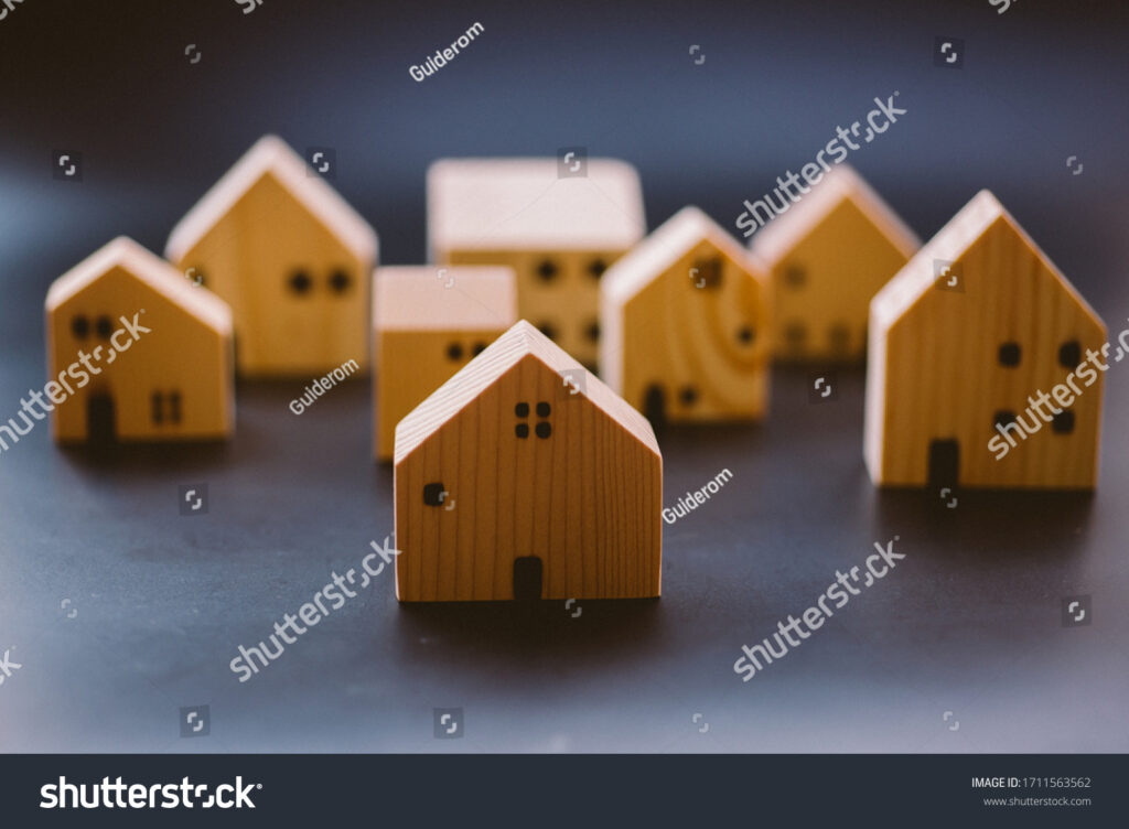 stock-photo-miniature-wooden-house-models-arranged-together-symbolizing-real-estate-housing-market-property-1711563562
